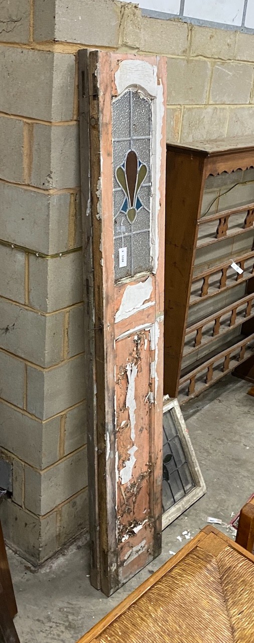 A pair of painted and stained glass inset doors, width 35cm height 209cm and a set of eight painted leaded glass windows, 46 x 51cm